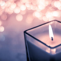 Blue aromatic candle on Christmas and New Years glitter background, Valentines Day luxury home decor and holiday season brand design Blue aromatic candle on Christmas and New Years glitter background, Valentines Day luxury home decor and holiday season brand design